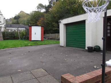 TempStor is in a customers garden. The image shows two garages and a basketball hoop on the right