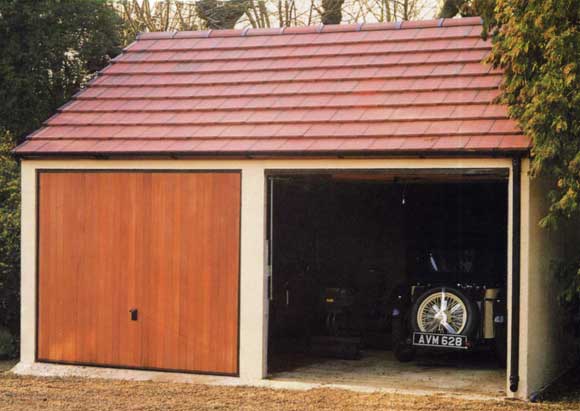 Concrete Garage Heritage - Double garage with one of the up and over doors open showing the back of an old classic car